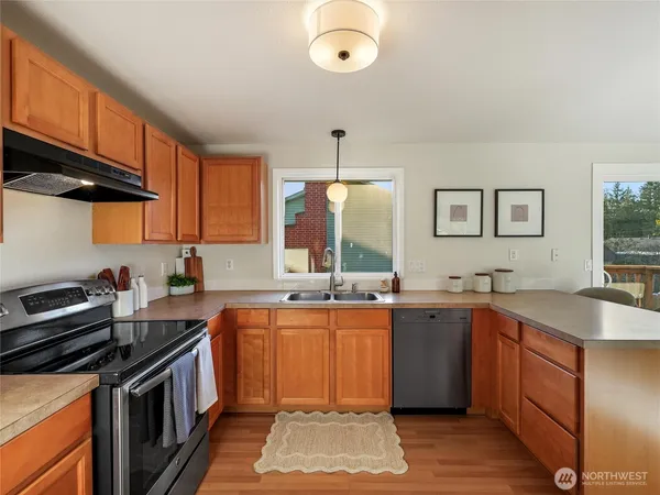 a kitchen with a sink stove and cabinets
