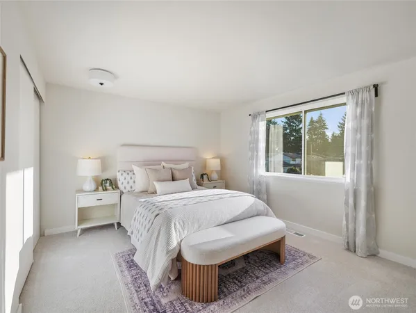 a bedroom with a bed and a window