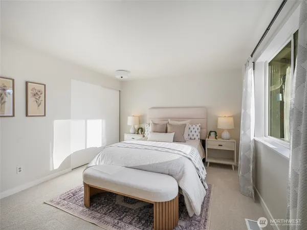 a bedroom with a bed and a lamp