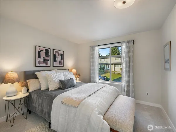 a bedroom with a bed and a window