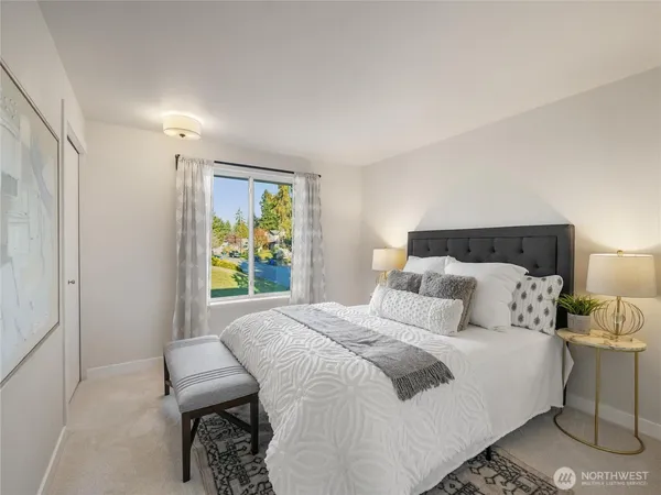 a bedroom with a bed and a window