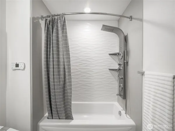 a bathroom with a shower and a bathtub