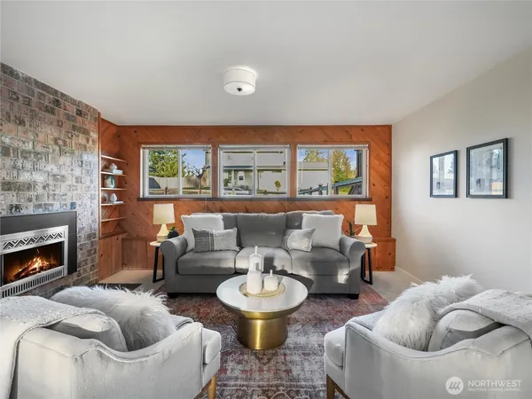 a living room with furniture and a fireplace