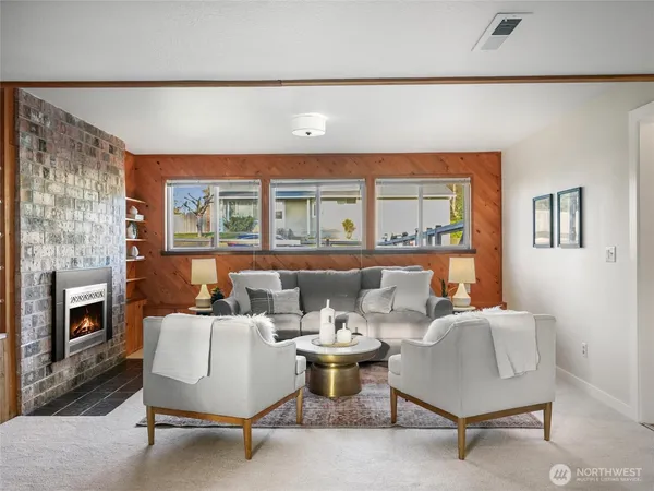 a living room with furniture and a fireplace