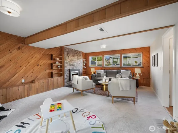 a living room with furniture and a floor to ceiling window