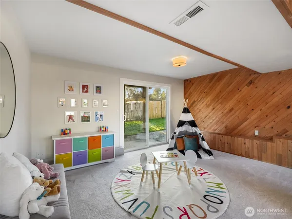 a living room with furniture and a floor to ceiling window