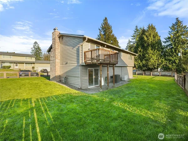 a view of a house with a yard patio and fire pit