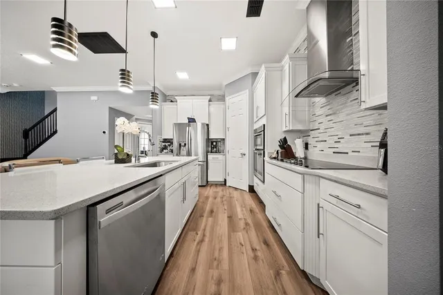 a large white kitchen with a large window