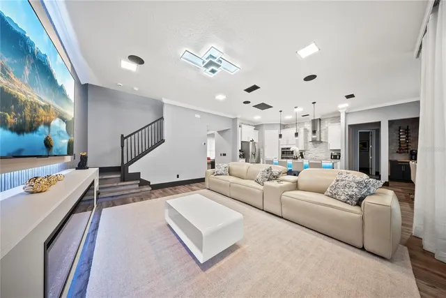 a living room with furniture and a wooden floor