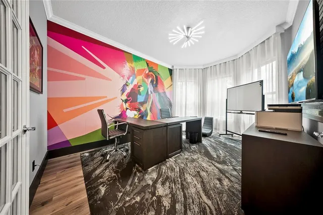 a living room with stainless steel appliances kitchen island granite countertop furniture and a flat screen tv