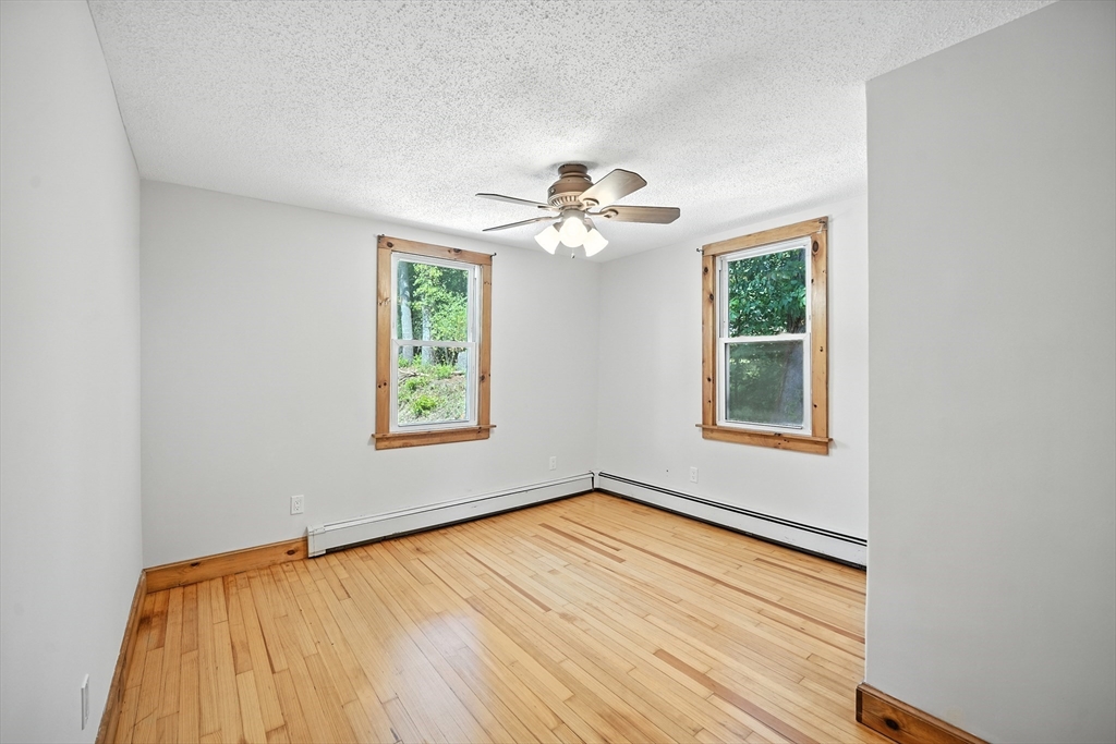61 West Street Ludlow, MA 01056 - Photo 11 of 29 a view of an empty room with a window and wooden floor