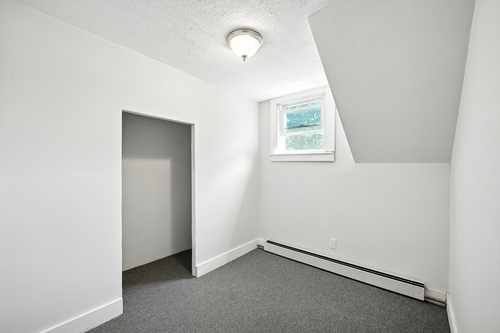 61 West Street Ludlow, MA 01056 - Photo 16 of 29 an empty room with a window