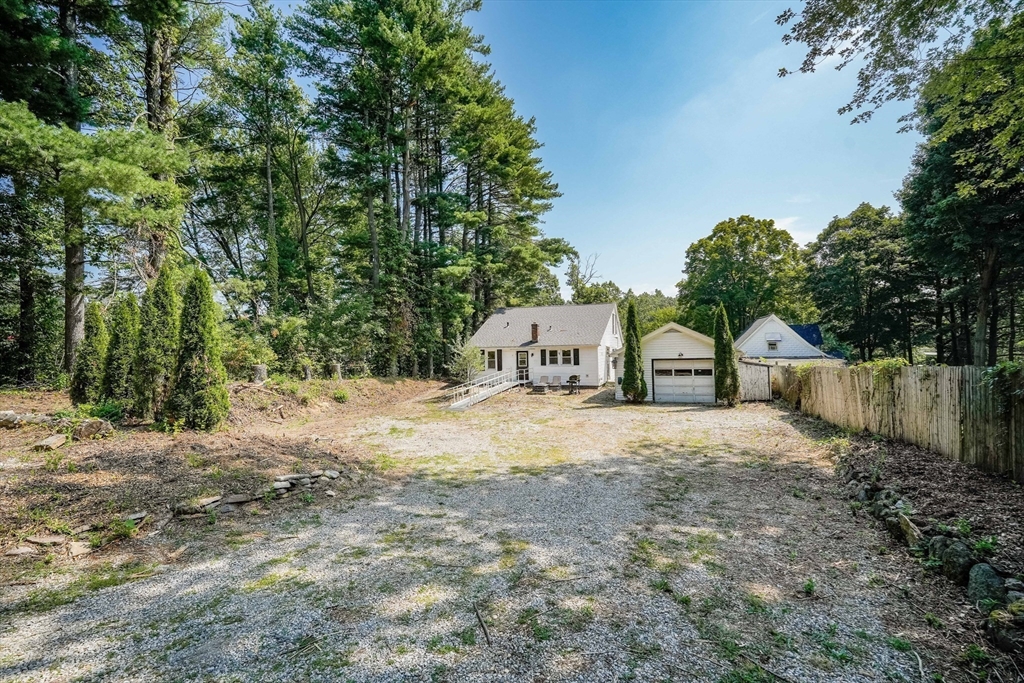 61 West Street Ludlow, MA 01056 - Photo 24 of 29 a large house with a big yard and large trees