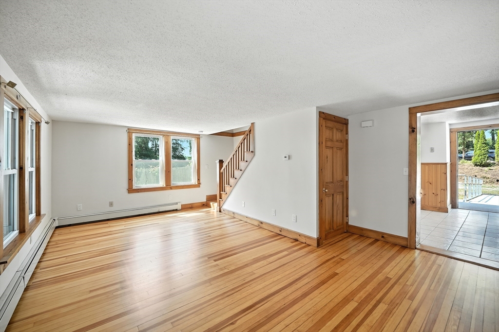 61 West Street Ludlow, MA 01056 - Photo 5 of 29 an empty room with wooden floor and windows