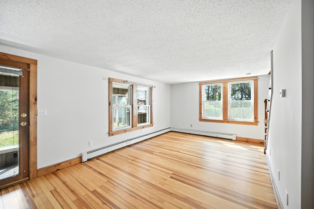 61 West Street Ludlow, MA 01056 - Photo 7 of 29 a view of an empty room with wooden floor and a window