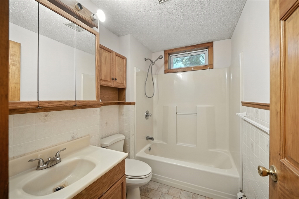 61 West Street Ludlow, MA 01056 - Photo 9 of 29 a bathroom with a sink toilet and shower
