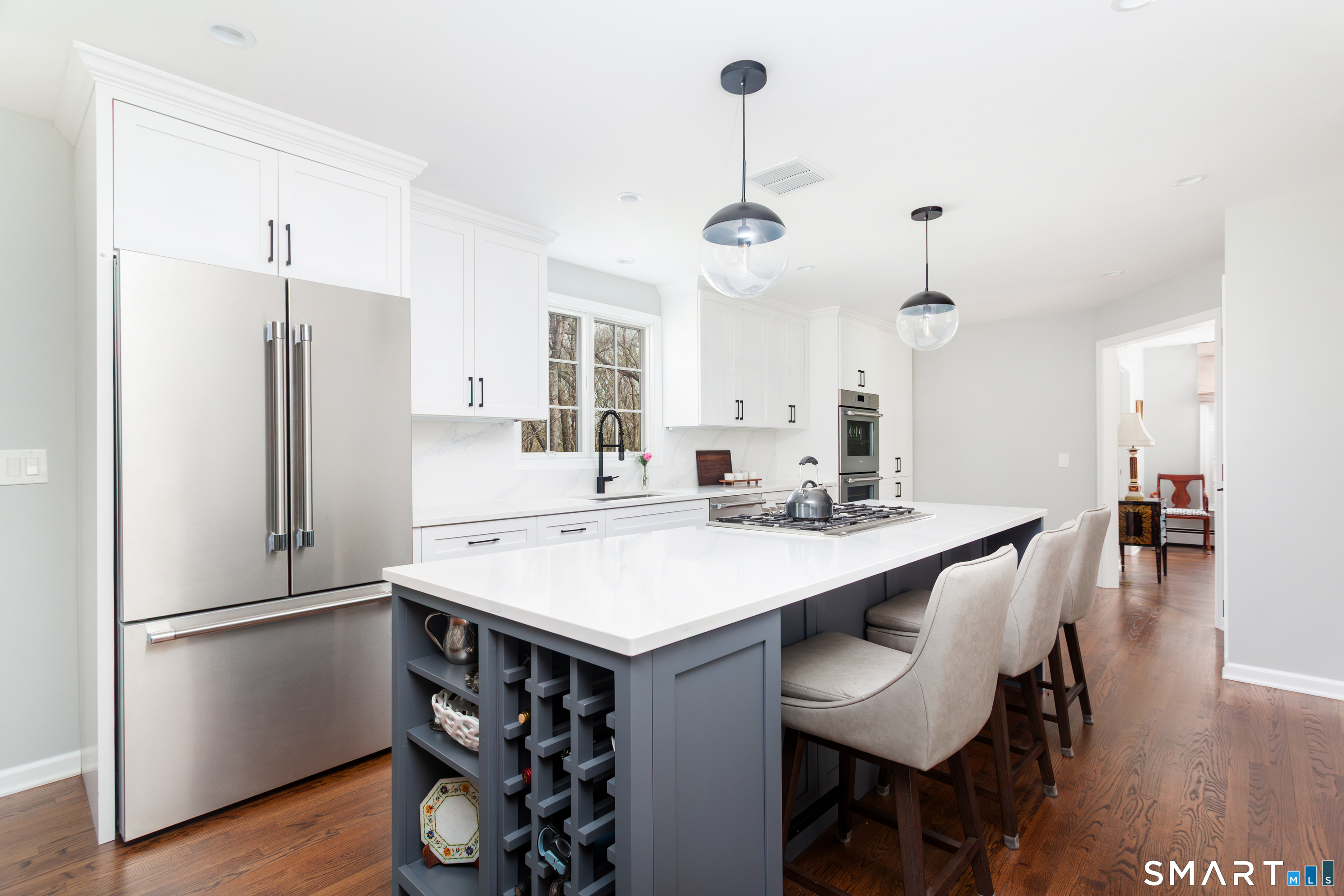 33 Cardinal Road Weston, CT 06883 - Photo 13 of 38 a kitchen with stainless steel appliances a dining table chairs refrigerator and sink
