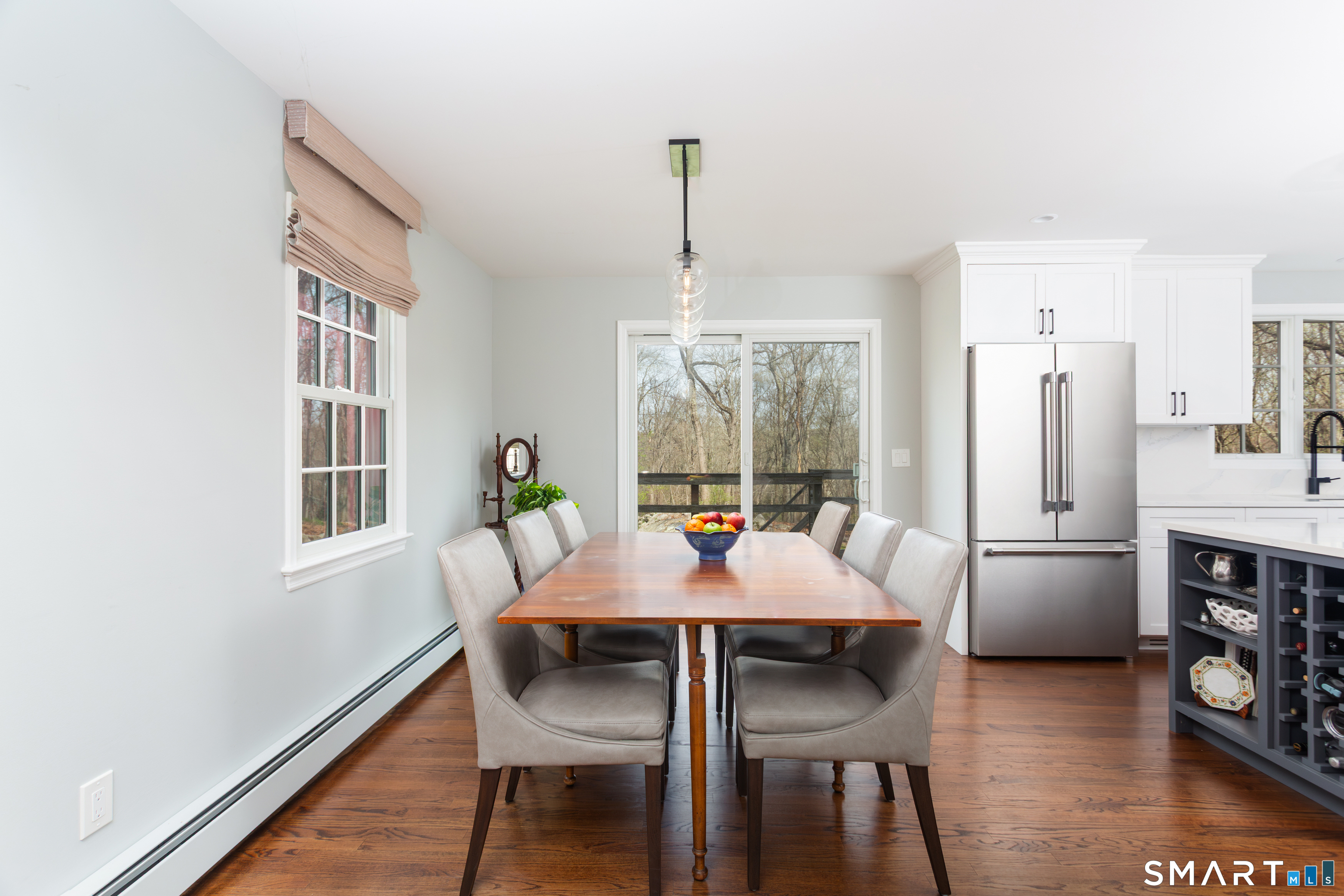 33 Cardinal Road Weston, CT 06883 - Photo 17 of 38 a dining room with furniture a chandelier and wooden floor