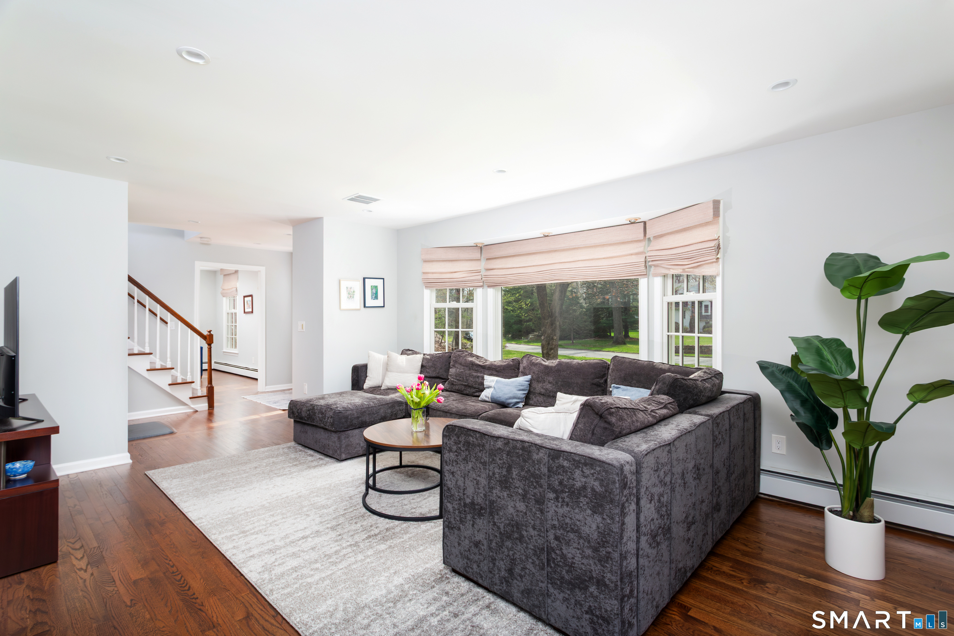 33 Cardinal Road Weston, CT 06883 - Photo 20 of 38 a living room with furniture potted plant and a large window