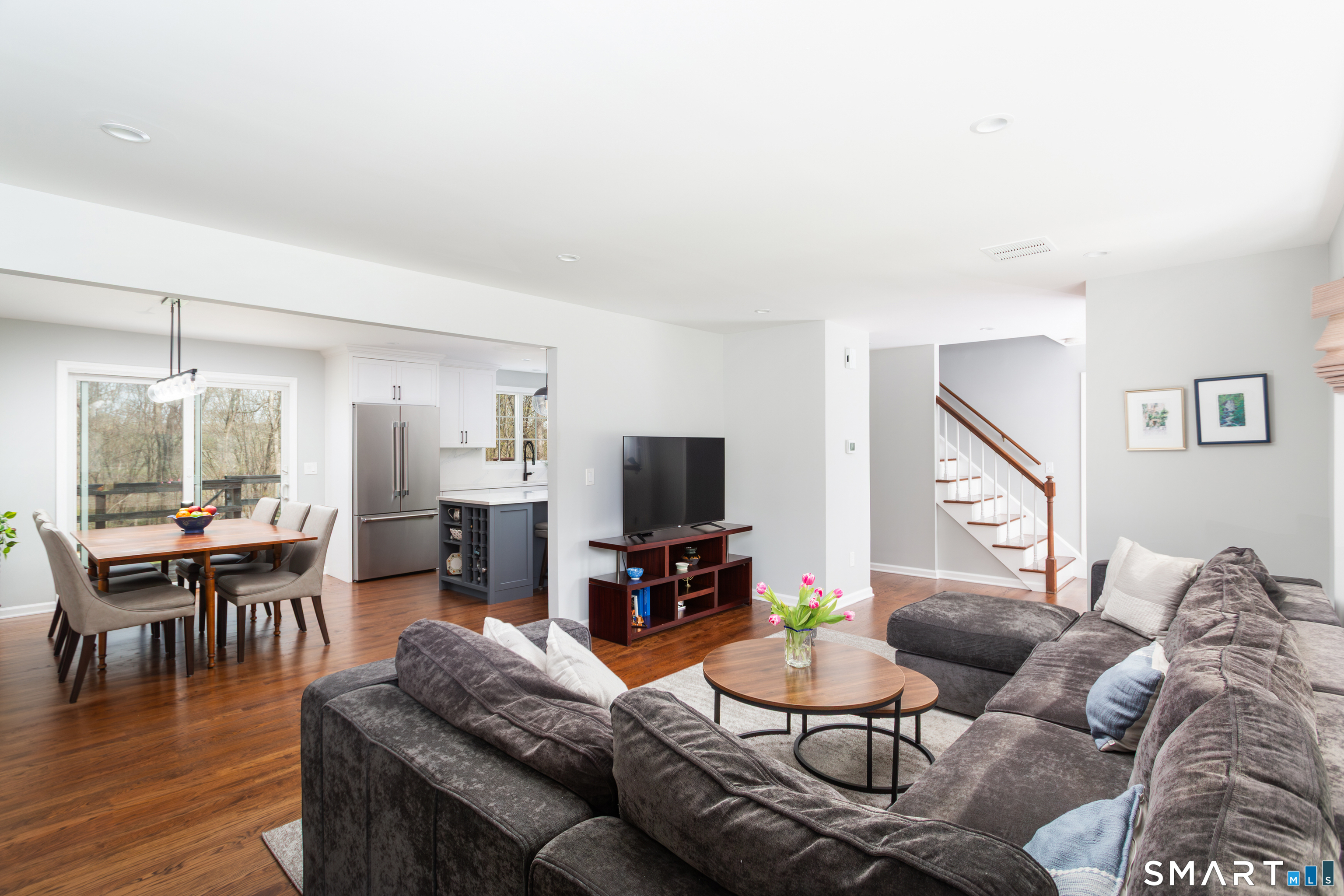 33 Cardinal Road Weston, CT 06883 - Photo 21 of 38 a living room with furniture a dining table and a wooden floor