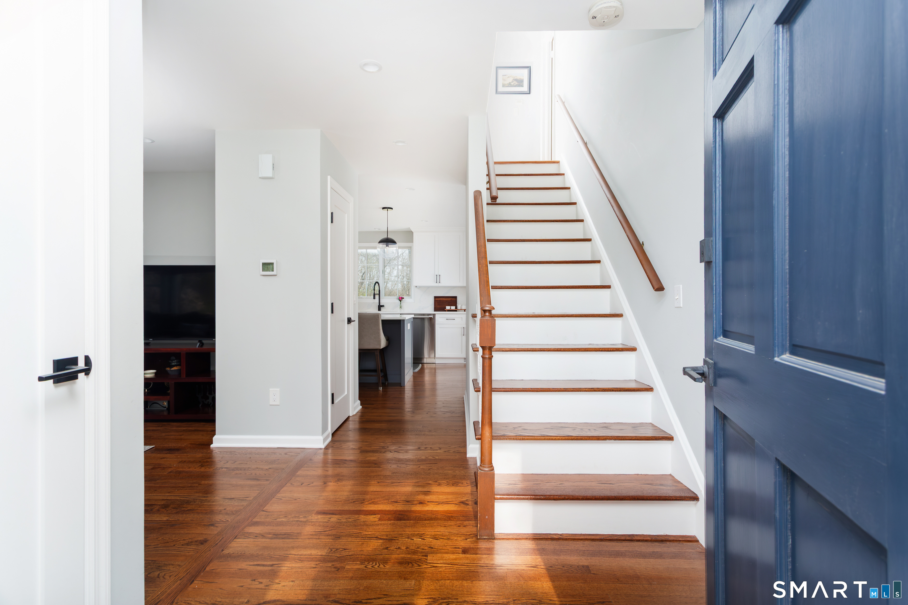 33 Cardinal Road Weston, CT 06883 - Photo 3 of 38 a view of an entryway with wooden floor and staircase