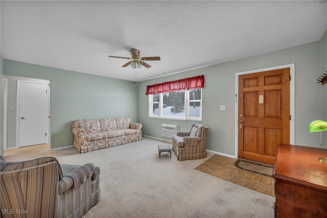 5651 Broadview Road, Unit C1 Cleveland, OH 44134 - Photo 6 of 23 Living room with light colored carpet, ceiling fan, a textured ceiling, and a wall unit AC