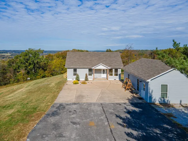 a aerial view of a house with a yard