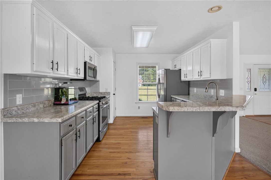 612 Providence Point Drive Seneca, SC 29678 - Photo 4 of 43 A well-appointed kitchen features ample counter space, modern appliances, and a convenient island.
