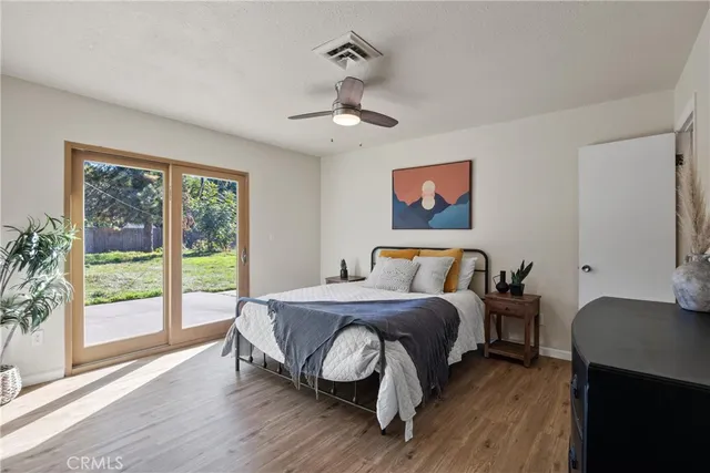 a bed sitting in a bedroom next to a window