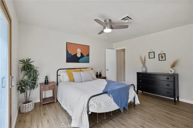 a bedroom with a bed and a potted plant