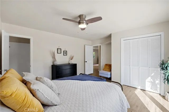 a bedroom with a bed and a chandelier