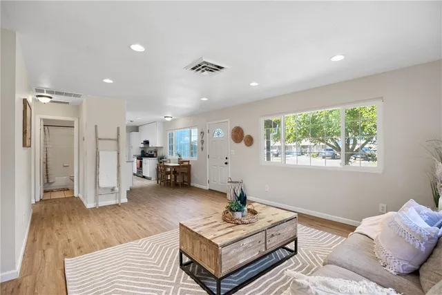 a living room with furniture and a wooden floor