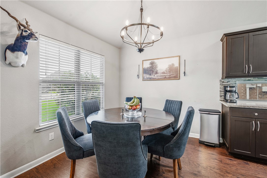 3014 Positano Loop Bryan, TX 77808 - Photo 7 of 23 a view of a dining room with furniture window and wooden floor