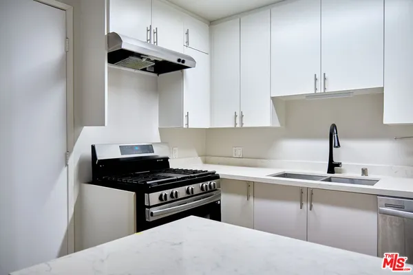 a kitchen with cabinets and appliances