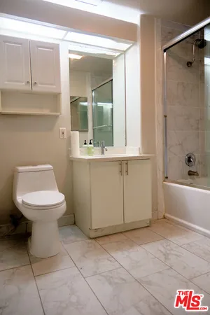 a bathroom with a toilet a sink and shower