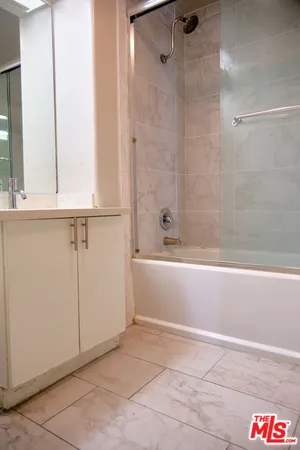 a bathroom with a bathtub and shower
