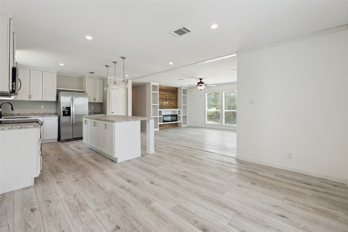 855 Roosevelt Road Kingsbury, TX 78638 - Photo 17 of 33 a view of a kitchen with wooden floor and electronic appliances
