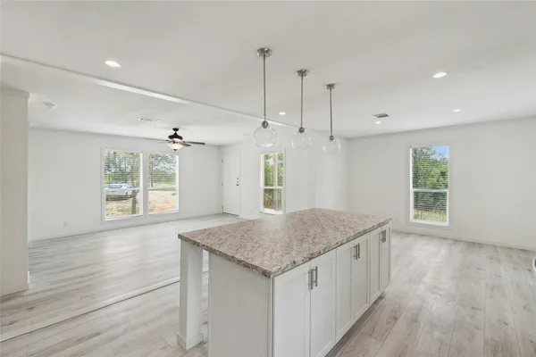 a kitchen with a wooden floor and window