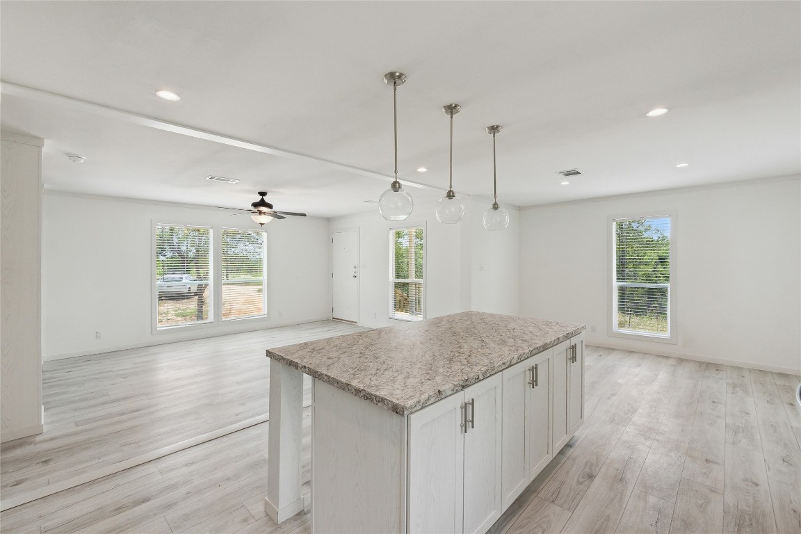 855 Roosevelt Road Kingsbury, TX 78638 - Photo 21 of 33 a kitchen with a wooden floor and window