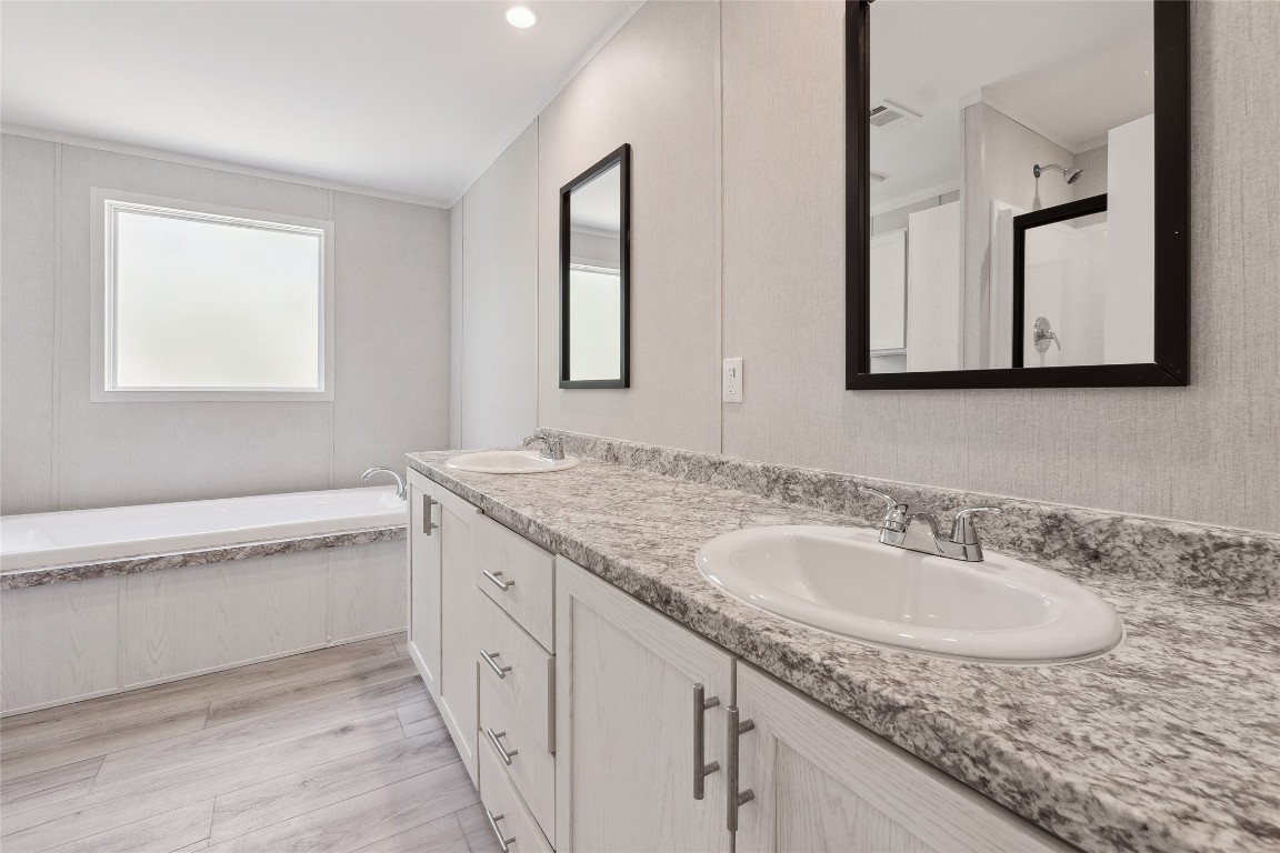 855 Roosevelt Road Kingsbury, TX 78638 - Photo 23 of 33 a bathroom with a granite countertop sink and a mirror