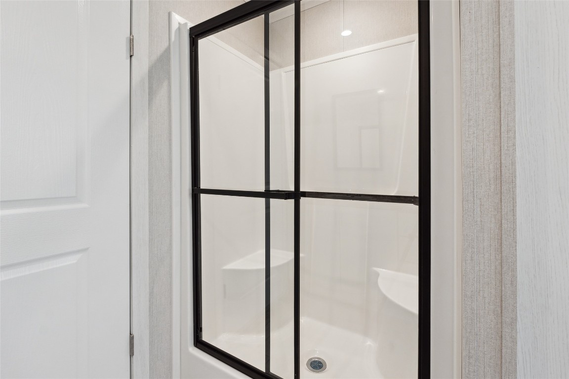 855 Roosevelt Road Kingsbury, TX 78638 - Photo 25 of 33 a bathroom with a glass shower door