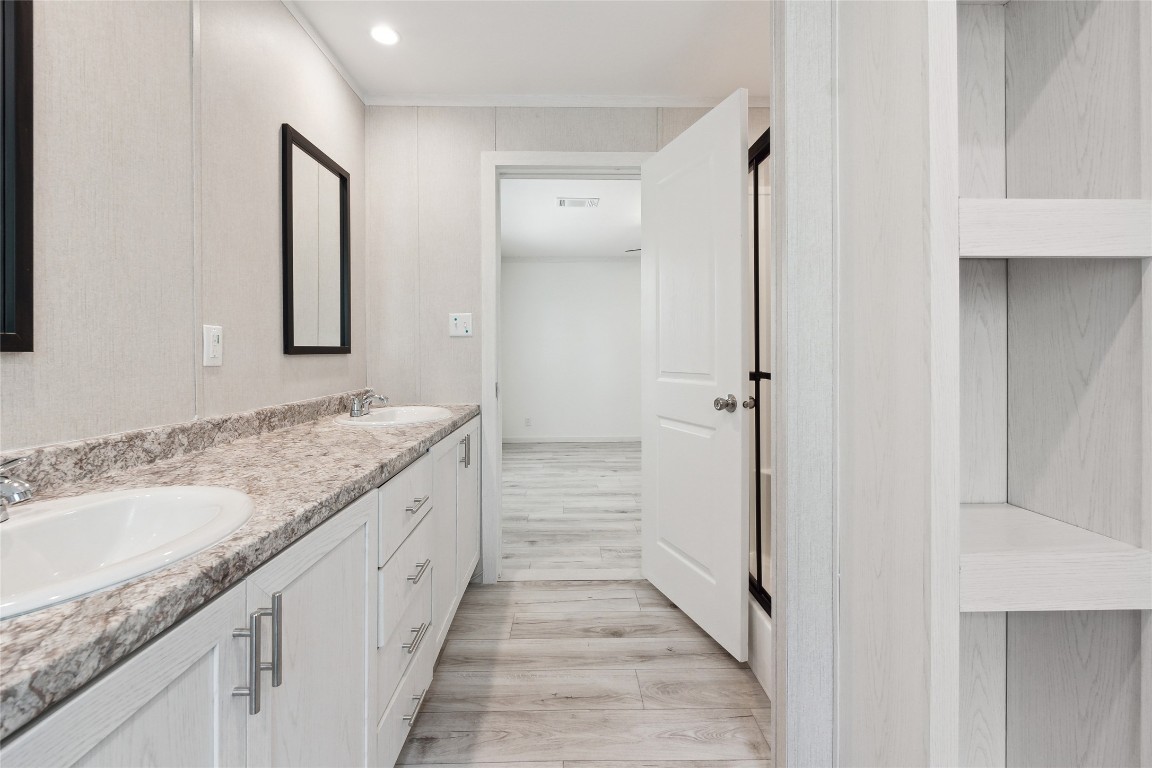 855 Roosevelt Road Kingsbury, TX 78638 - Photo 26 of 33 a bathroom with a granite countertop sink and a mirror