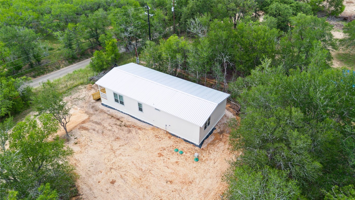855 Roosevelt Road Kingsbury, TX 78638 - Photo 32 of 33 a view of a small house with a yard and a wooden fence