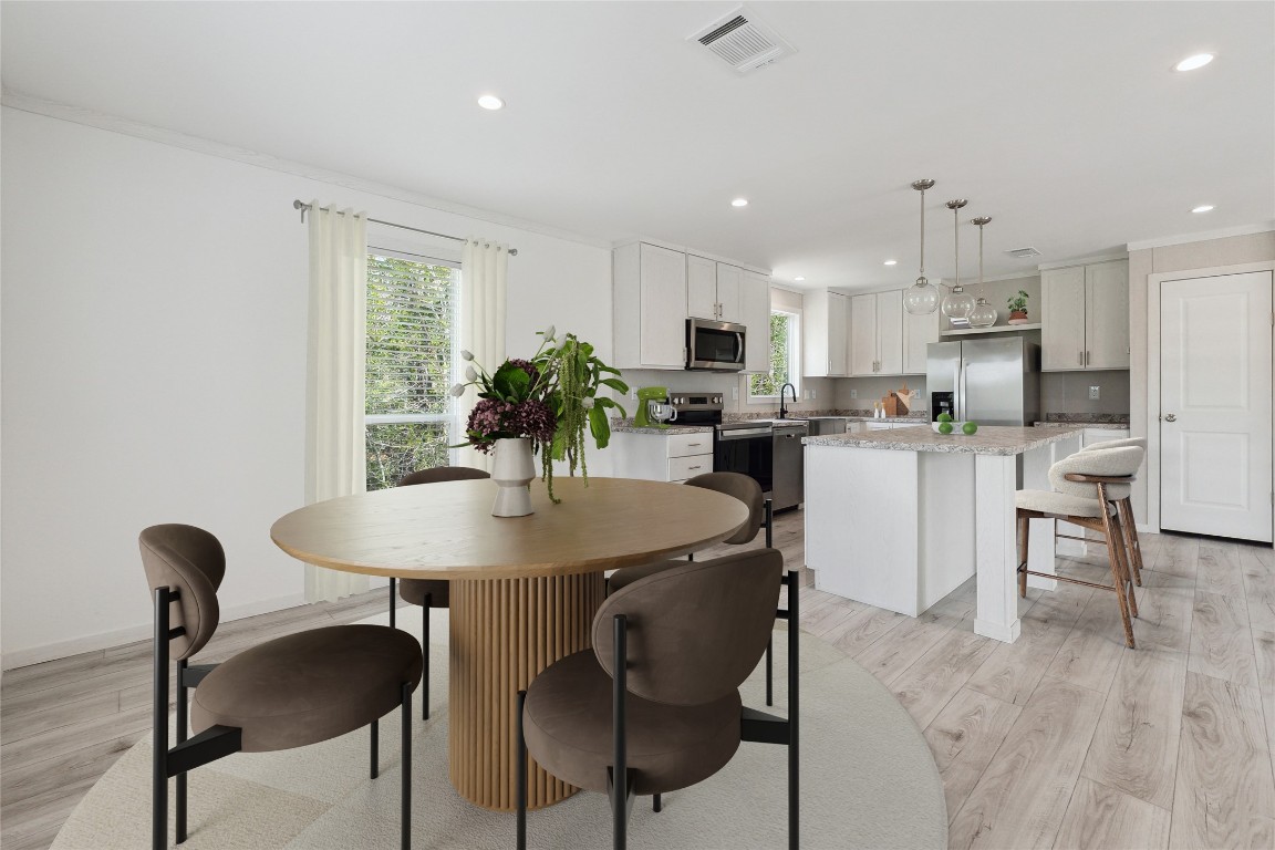 855 Roosevelt Road Kingsbury, TX 78638 - Photo 5 of 33 a kitchen with kitchen island a dining table chairs stainless steel appliances and cabinets