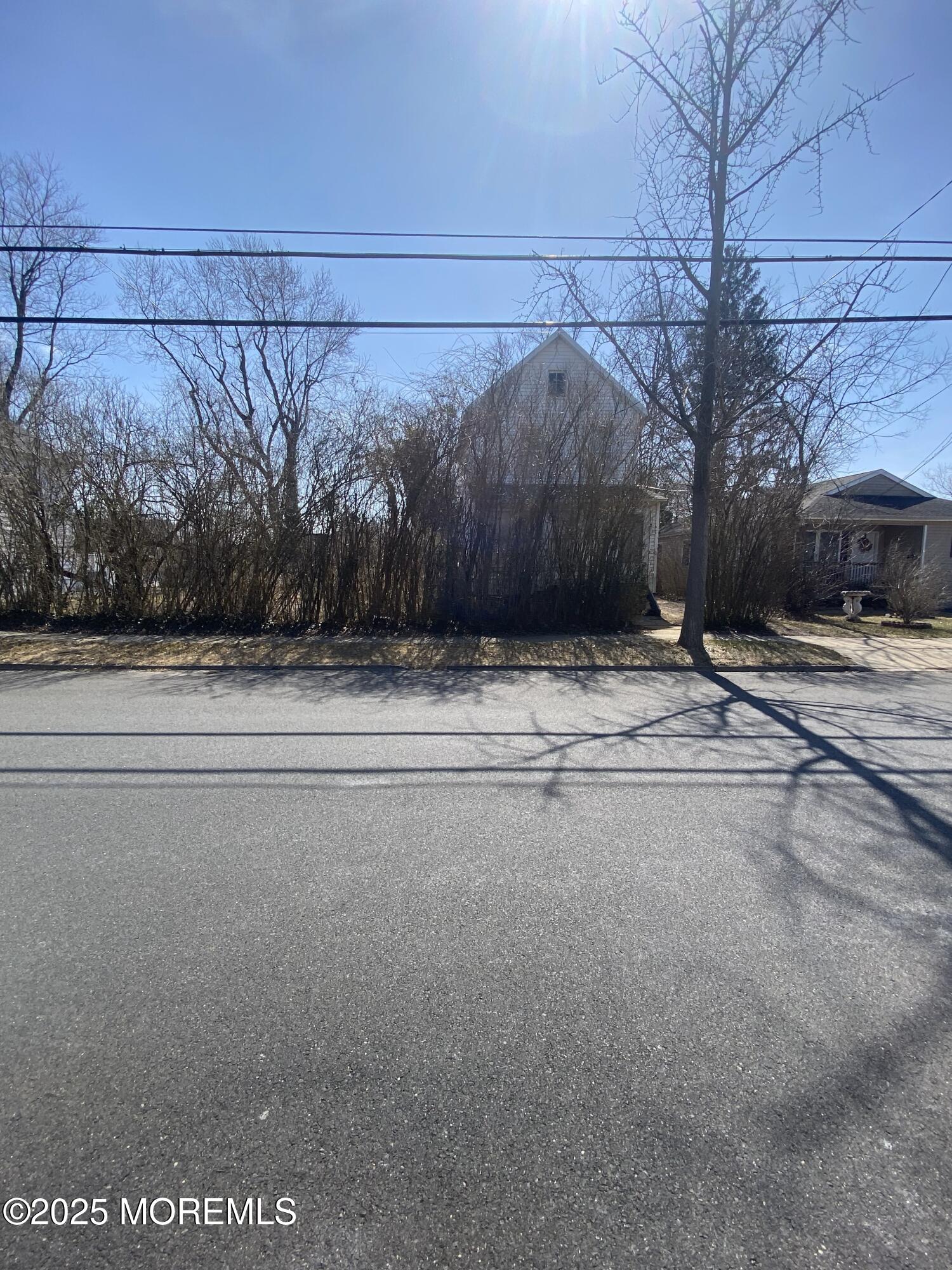 a white house with a snow on the road