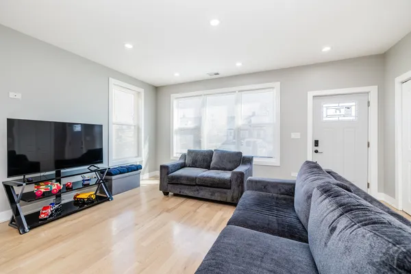 an empty room with wooden floor and window