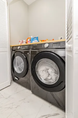 a bathroom with a double vanity sink mirror and bathtub