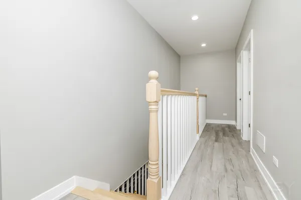 a view of a back yard of the house with a large tree