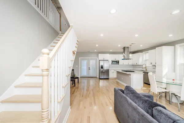 a view of a room with wooden floor and staircase
