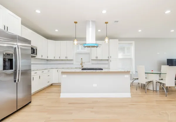 a bedroom with a bed a couch and a desk in it